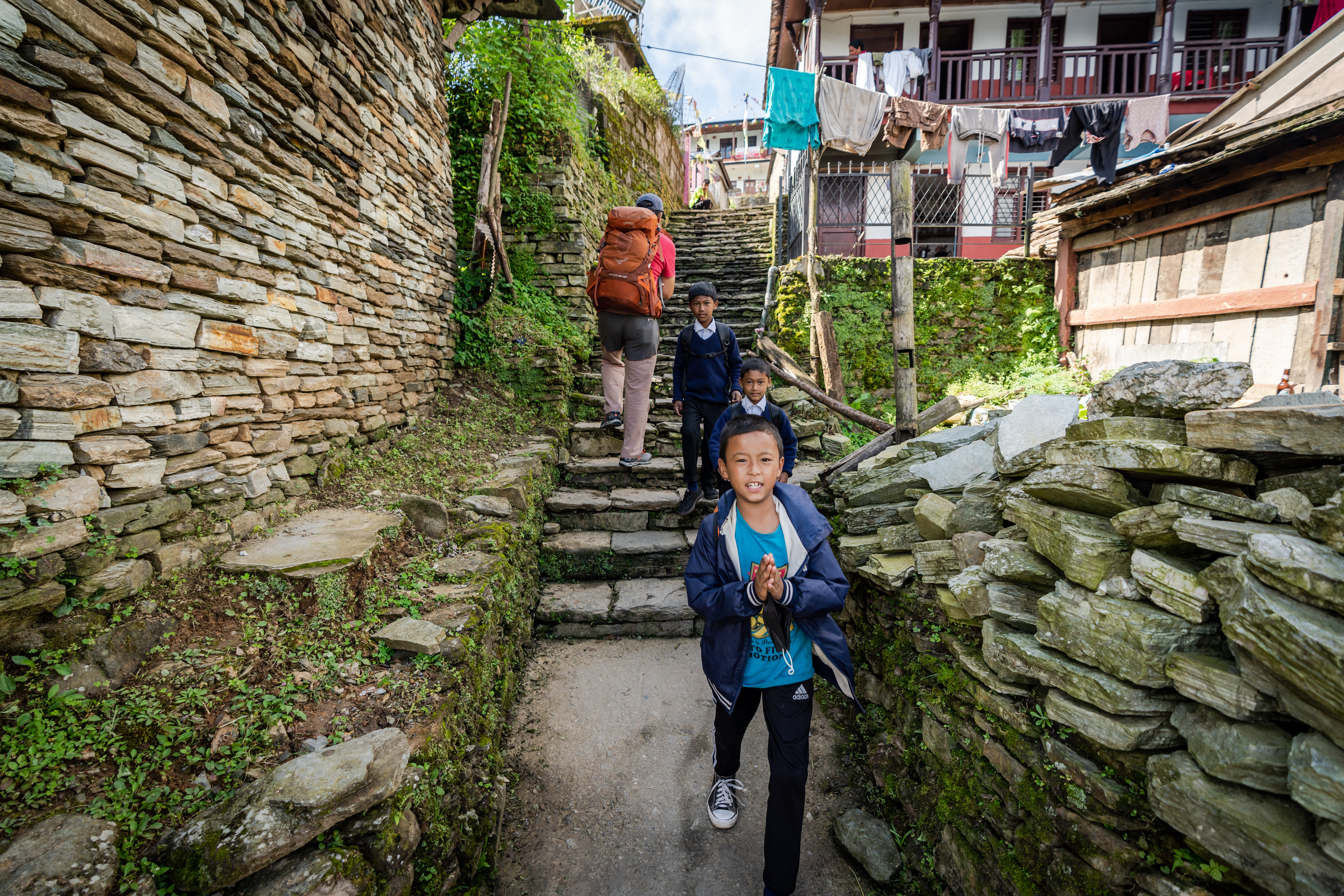 3 boys walking to school in Ghandruk, Nepal