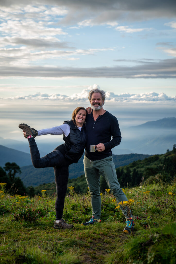 A couple poses at the top of Poon Hill in Nepal.