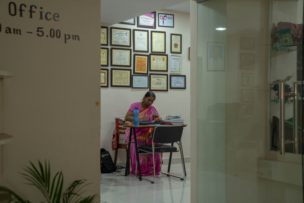 A woman working at her desk at the Sambhali Trust office in Jodhpur, India.