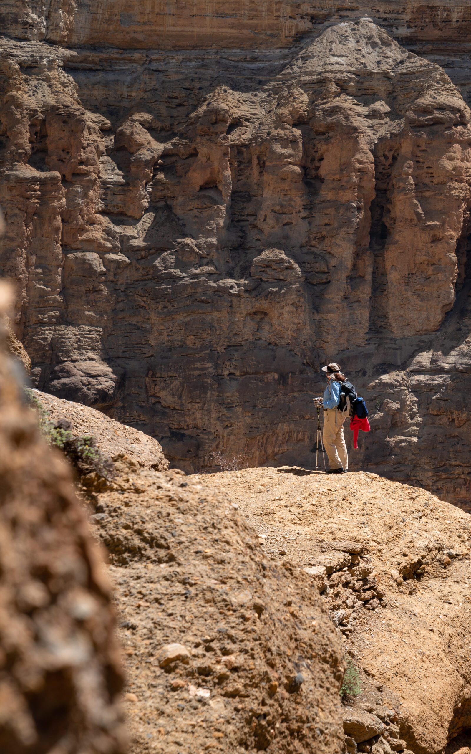 A woman hiking in a geographically unique canyon in the Upper Mustang in Nepal.