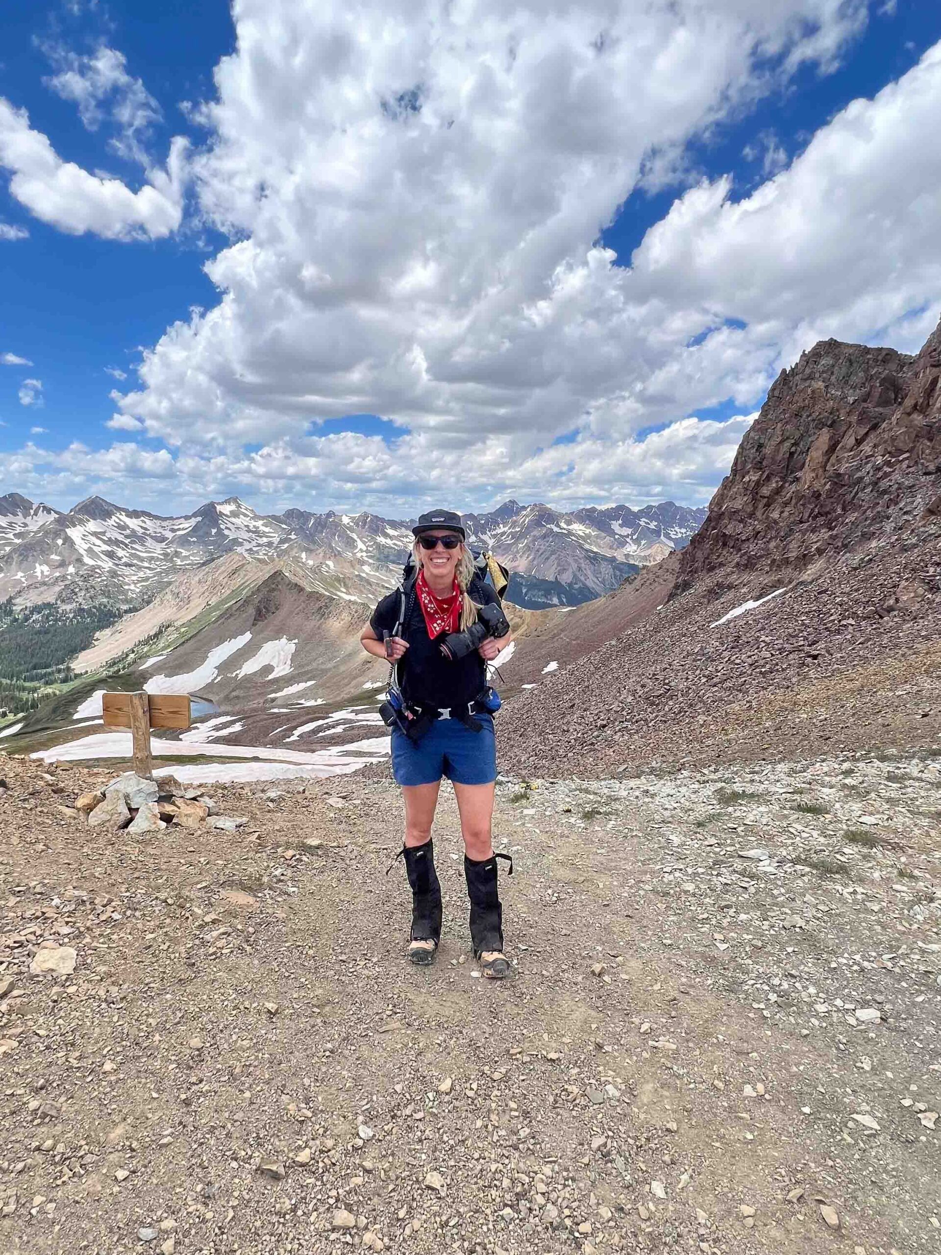 Hilary Lex stands at the top of Triangle Pass at 12,900 feet elevation while hiking to Conundrum Hot Springs in between Crested Butte and Aspen, Colorado.
