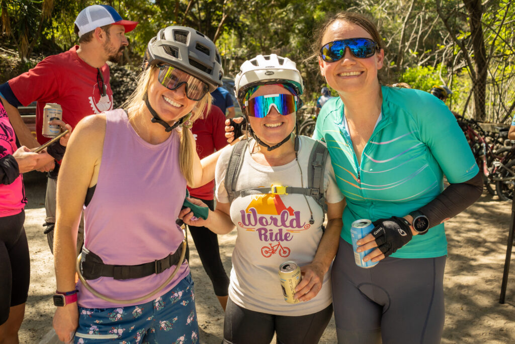 The owner of Shredly, Ashley Rankin, smiles with a woman wearing a World Ride tshirt at the finish line of the World Ride travesia event in Guatemala.