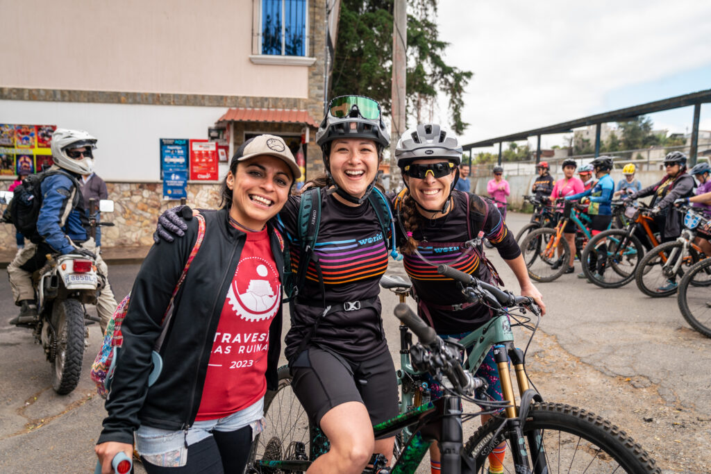 The executive director of World Ride, Julie Cornelius, smiles with friends Jess Hana and Christa Castillo at the start line of the World Ride travesia in Guatemala.