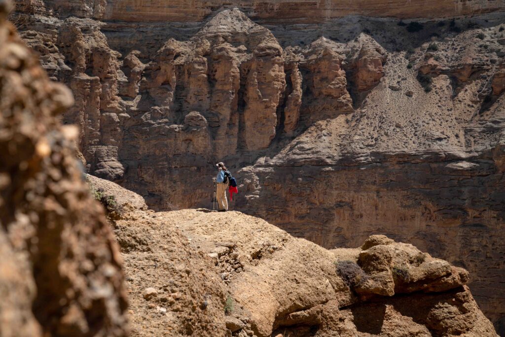 A woman hiking in a canyon in the Upper Mustang, Nepal.